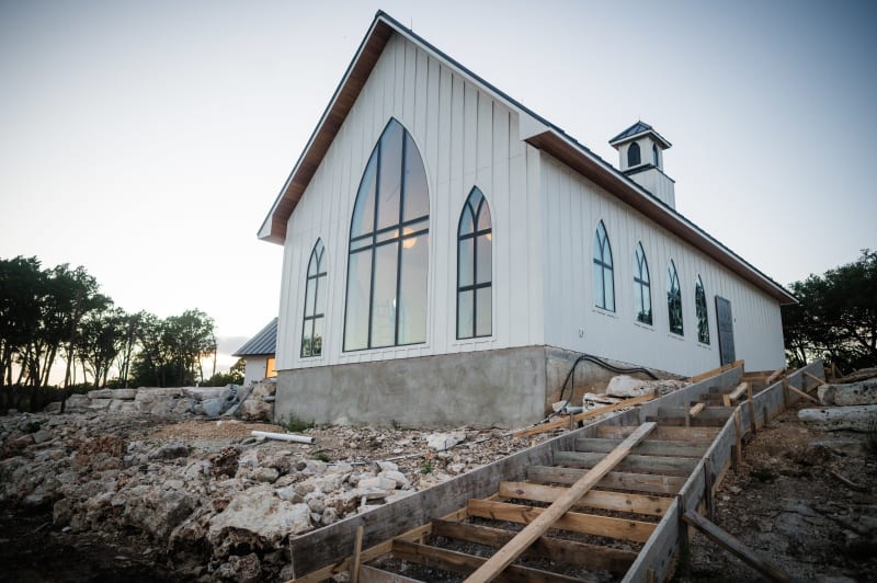Exterior of The Chapel at Wimberley with arched windows at golden hour