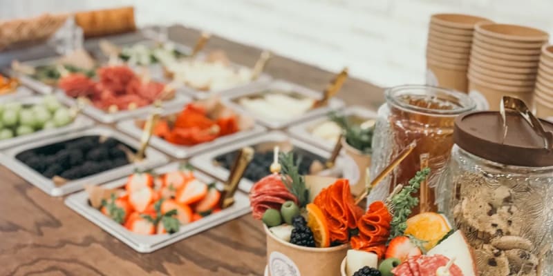 Charcuterie cart styled with cheeses, cured meats, fruits, and accompaniments